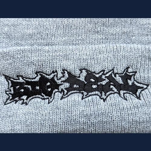 Embroidered Beanie Black on Gray Closeup