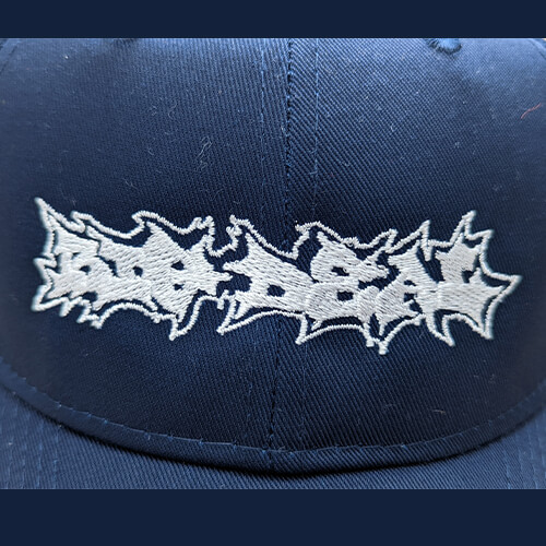 Embroidered Hat White on Navy Closeup